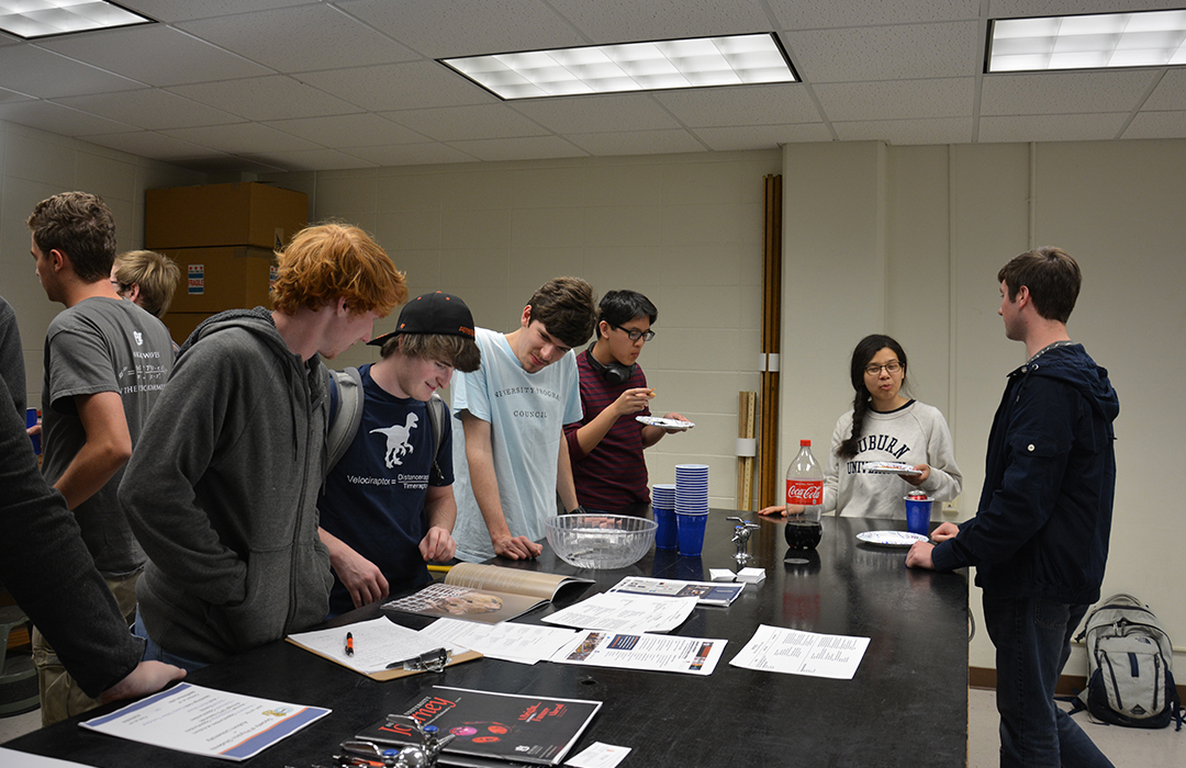 Students at a social hours for the Society of Physics Students gather in the Leach Science Center to meet new people and have fun.