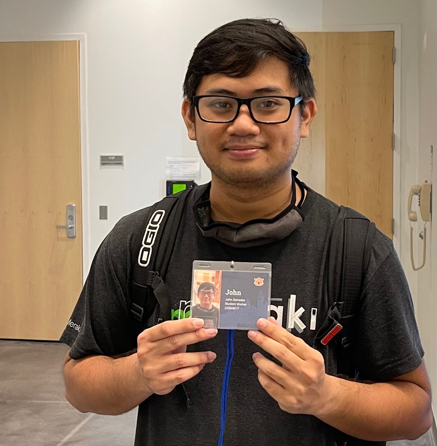 COSAM Student Worker Holding a Badge