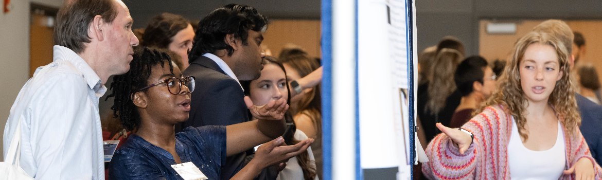 students look at a research display poster