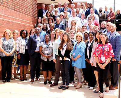 Economic Development class poses for photo on stairs.