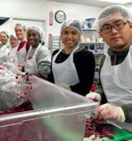 Students in kitchen pose for photo