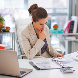 Woman at desk looking at papers