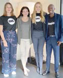 Three women and one man pose for photo together