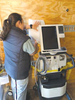 Lady stands in front of machine