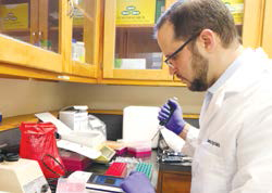 Lab guy with white coat and gloves