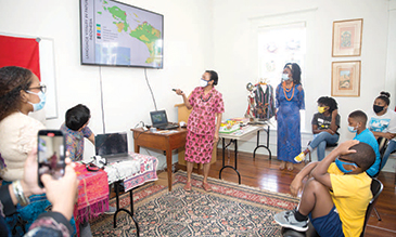 Group of students looks at projector screen while multicultural presentation is shown