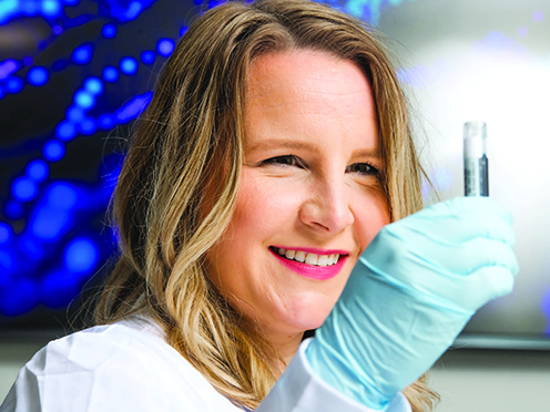 Pharmacist holding up sample in a lab