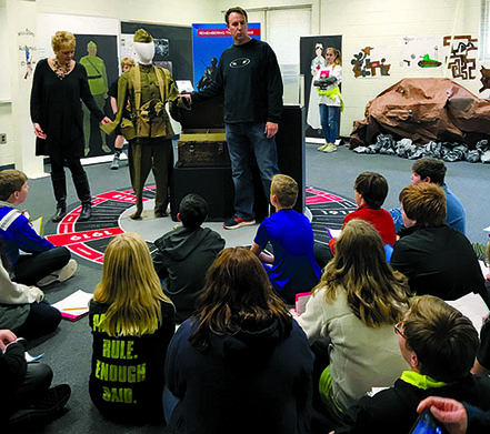 Social studies teach Beverly Helm and Russ Jenkins discuss the soldier's experiance in World War I with sixth-graders at Drake Middle School