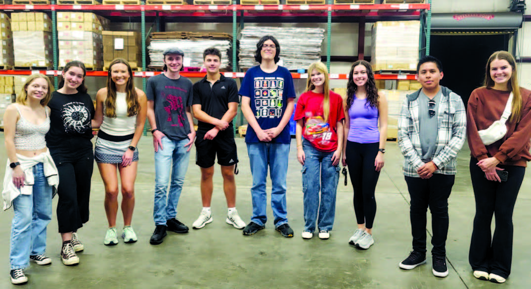 Senior boxes packing at East AL Food Bank with Lee Scott and Auburn High School Key Clubs and Kiwanis members.