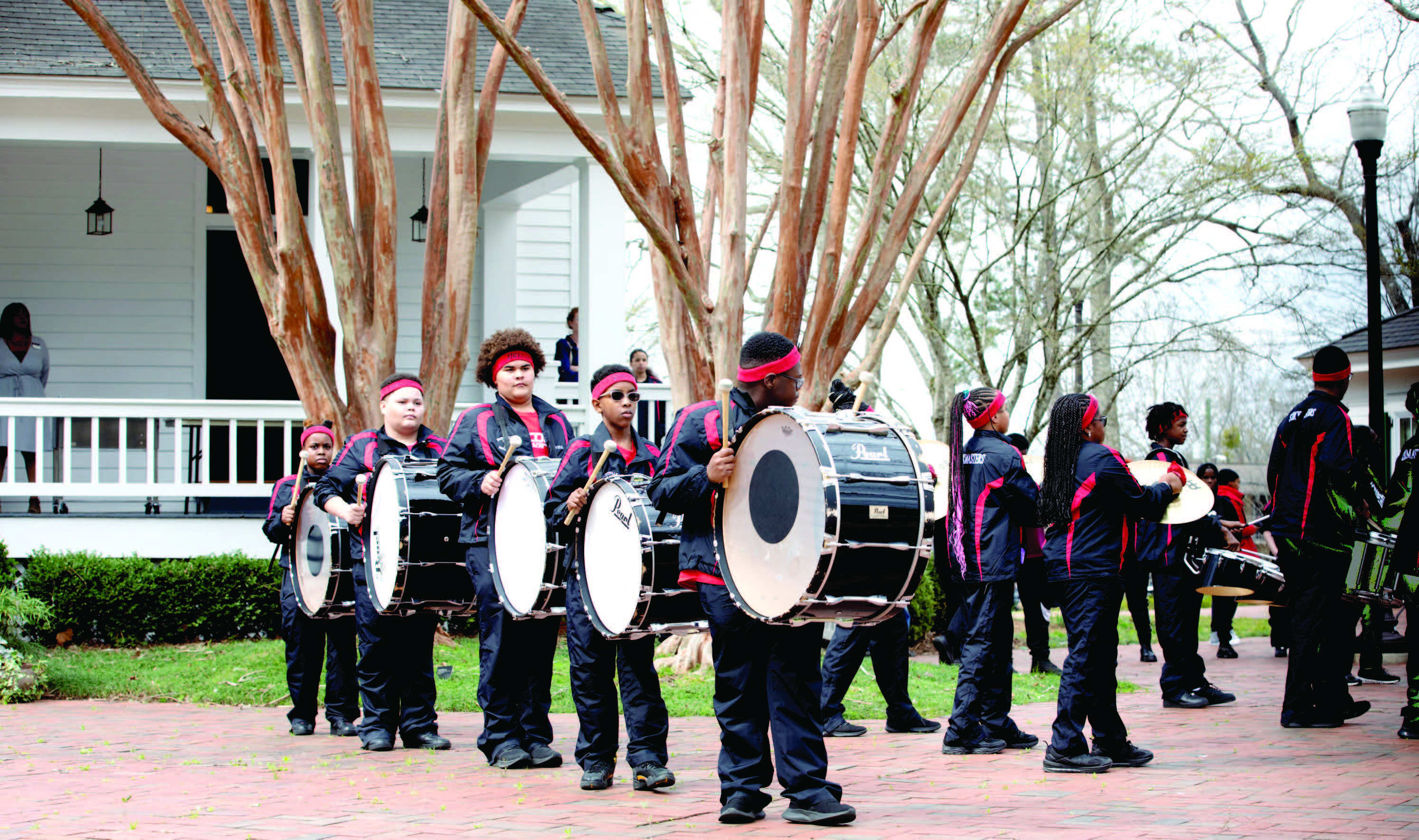 Students performing on bass drums.