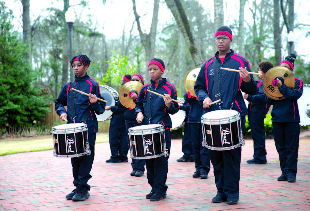 Students performing on snare drums.