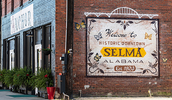 A painted brick wall on an old building welcomes visitors to Selma